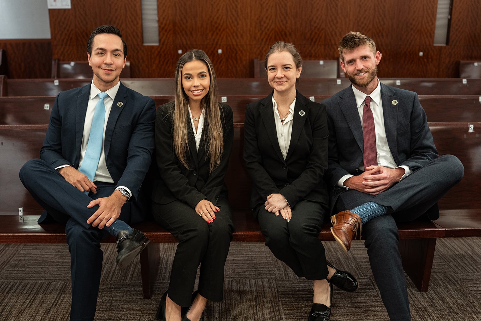 Young women and men sitting in a courtroom